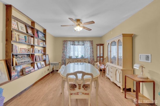 28 Lehigh St, Dunellen, NJ 08812 - dining area with radiator, light wood-style floors, and a ceiling fan
