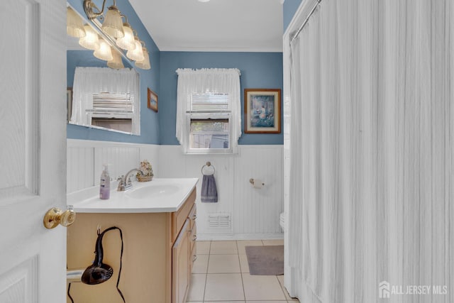 28 Lehigh St, Dunellen, NJ 08812 - full bathroom with vanity, a chandelier, a wainscoted wall, and tile patterned floors