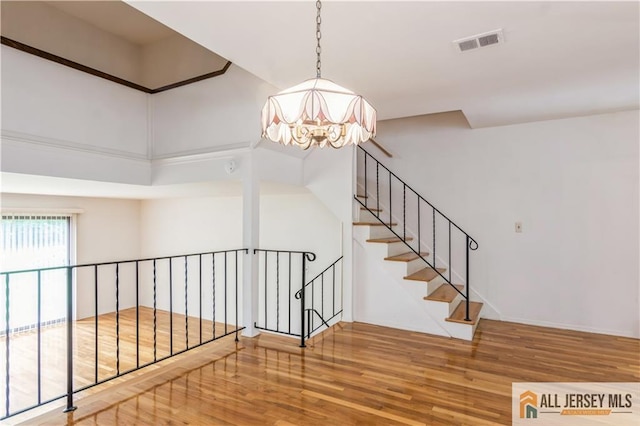 323 Gills Ln Unit 9C, Iselin, NJ 08830 - stairway with a chandelier and wood finished floors