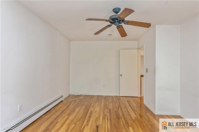 323 Gills Ln Unit 9C, Iselin, NJ 08830 - spare room featuring a baseboard radiator, wood finished floors, and a ceiling fan