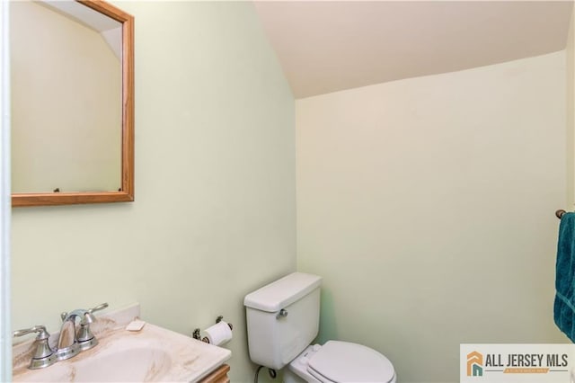 323 Gills Ln Unit 9C, Iselin, NJ 08830 - bathroom featuring toilet, vaulted ceiling, and vanity