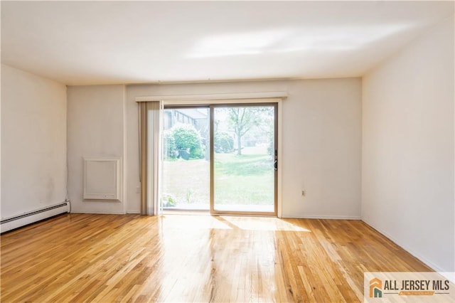 323 Gills Ln Unit 9C, Iselin, NJ 08830 - spare room featuring light wood-style floors, baseboards, and a baseboard radiator