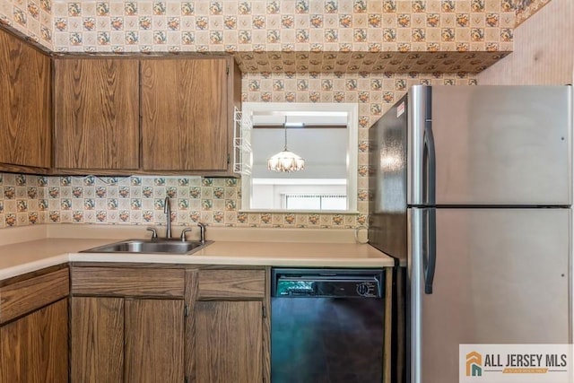 323 Gills Ln Unit 9C, Iselin, NJ 08830 - kitchen with freestanding refrigerator, dishwasher, a sink, brown cabinets, and wallpapered walls