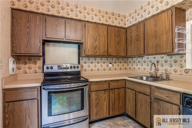 323 Gills Ln Unit 9C, Iselin, NJ 08830 - kitchen with stainless steel electric range, light countertops, backsplash, and dishwasher