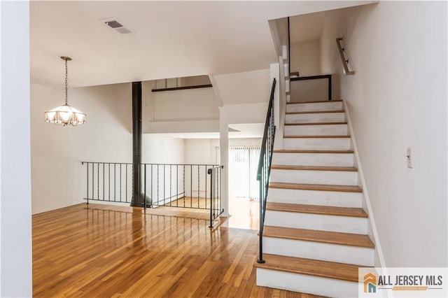 323 Gills Ln Unit 9C, Iselin, NJ 08830 - stairs with wood finished floors and a chandelier