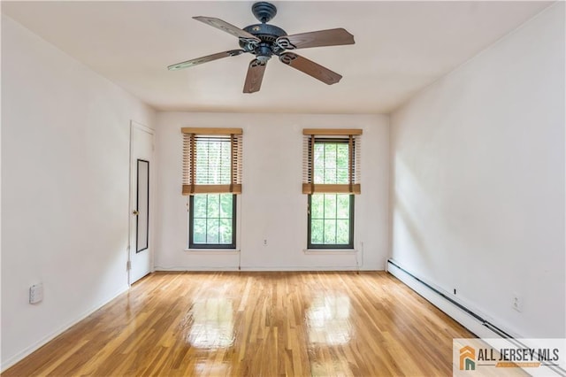 323 Gills Ln Unit 9C, Iselin, NJ 08830 - empty room featuring baseboard heating, light wood finished floors, and ceiling fan