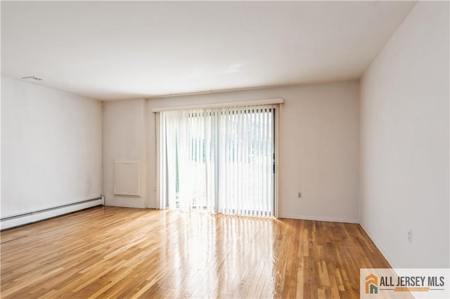 323 Gills Ln Unit 9C, Iselin, NJ 08830 - empty room with a baseboard heating unit and wood finished floors