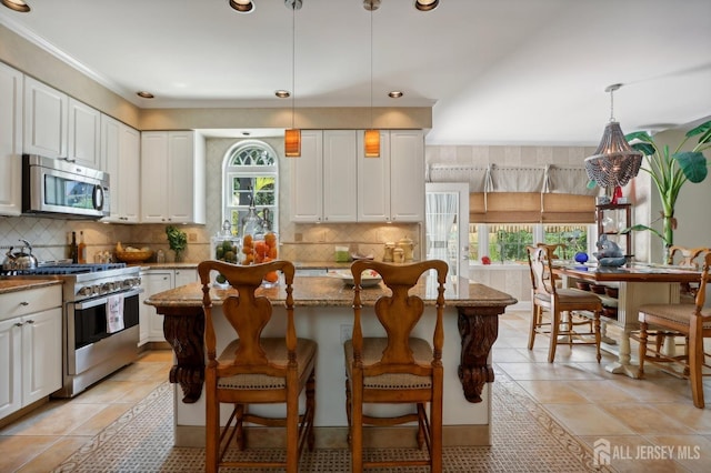 kitchen with white cabinetry, a wealth of natural light, and stainless steel appliances