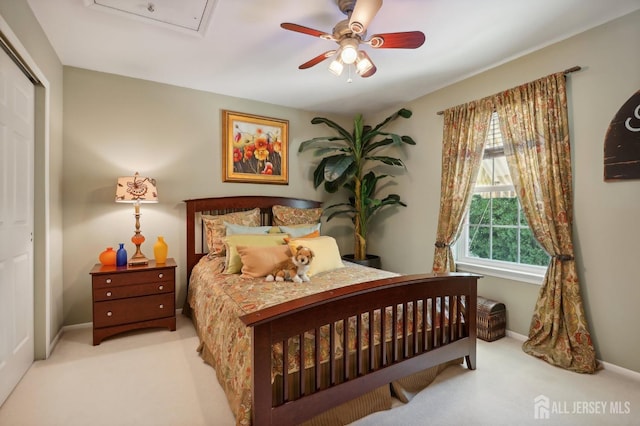 carpeted bedroom with ceiling fan and a closet