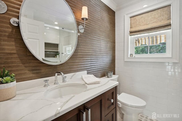 bathroom with vanity, toilet, and crown molding