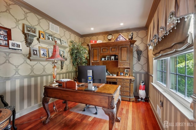 home office with light hardwood / wood-style flooring and ornamental molding