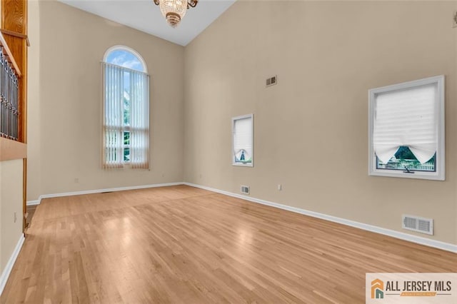 10 Signal Ct, South Brunswick, NJ 08810 - empty room with light wood-style floors, baseboards, and a high ceiling