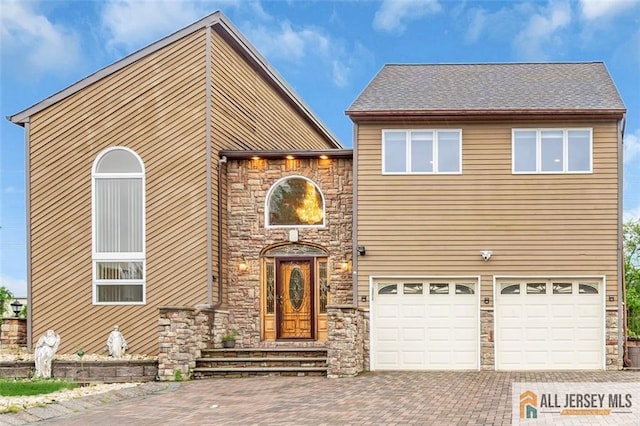 10 Signal Ct, South Brunswick, NJ 08810 - view of front facade with a garage, decorative driveway, and stone siding