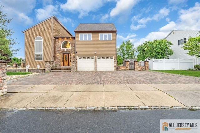 10 Signal Ct, South Brunswick, NJ 08810 - view of front facade featuring decorative driveway, stone siding, and fence