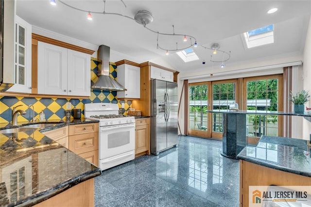 10 Signal Ct, South Brunswick, NJ 08810 - kitchen featuring gas range gas stove, stainless steel fridge with ice dispenser, wall chimney range hood, a skylight, and granite floors