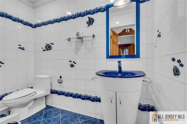10 Signal Ct, South Brunswick, NJ 08810 - bathroom with tile walls, ornamental molding, tile patterned flooring, toilet, and vanity