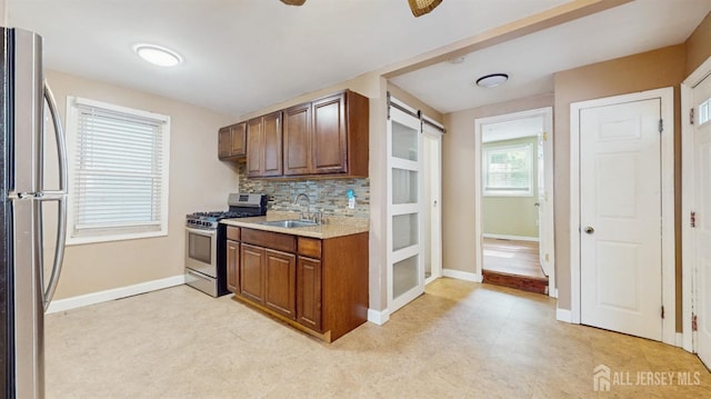811 Shore Concourse, Keyport, NJ 07735 - kitchen with appliances with stainless steel finishes, a sink, light countertops, tasteful backsplash, and baseboards
