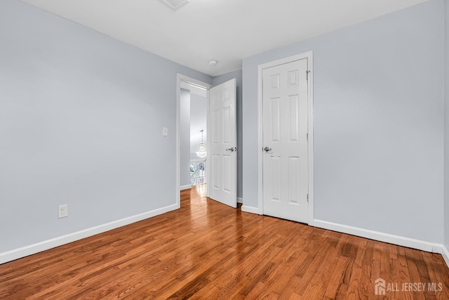 34 Sims Rd, Edison, NJ 08817 - unfurnished bedroom featuring baseboards and wood finished floors
