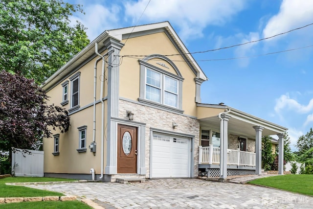 34 Sims Rd, Edison, NJ 08817 - view of front of property featuring covered porch, stucco siding, stone siding, and an attached garage