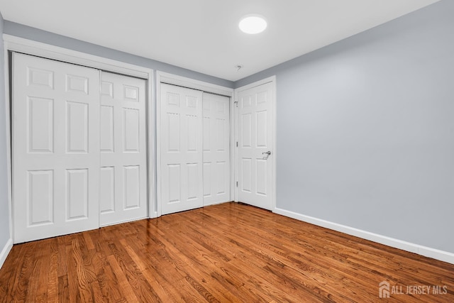 34 Sims Rd, Edison, NJ 08817 - unfurnished bedroom featuring wood finished floors and multiple closets