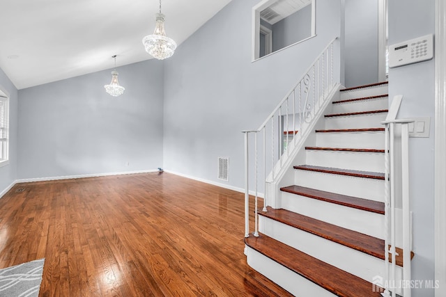 34 Sims Rd, Edison, NJ 08817 - stairway featuring a chandelier, vaulted ceiling, and wood-type flooring