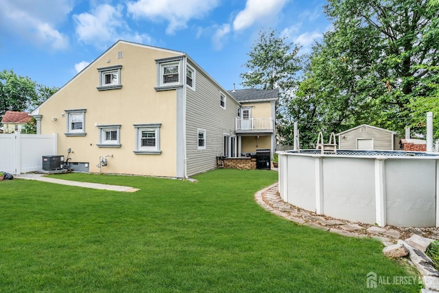 34 Sims Rd, Edison, NJ 08817 - rear view of house featuring an outdoor pool, a balcony, and stucco siding