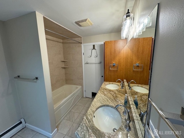 bathroom featuring vanity, tile patterned flooring, a baseboard heating unit, and tiled shower / bath