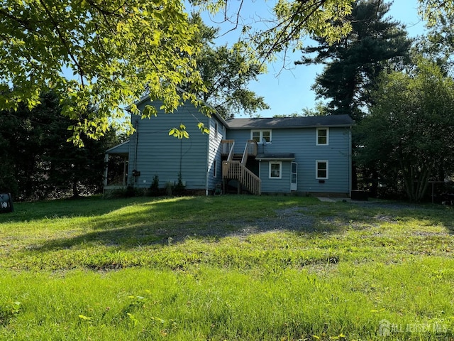 back of property featuring a lawn