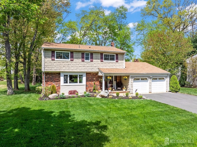 view of front of house featuring a chimney, a garage, driveway, and a front lawn
