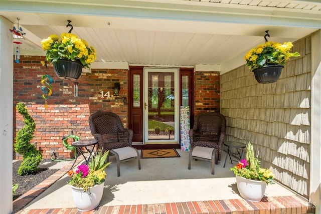 14 Appleby Ln, East Brunswick, NJ 08816 - doorway to property featuring covered porch and brick siding
