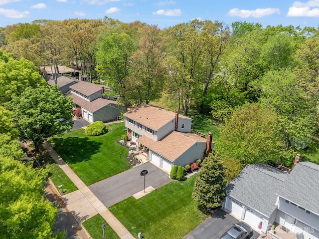 aerial view of residential area featuring a heavily wooded area