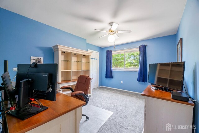 office space with a ceiling fan, carpet flooring, and baseboards