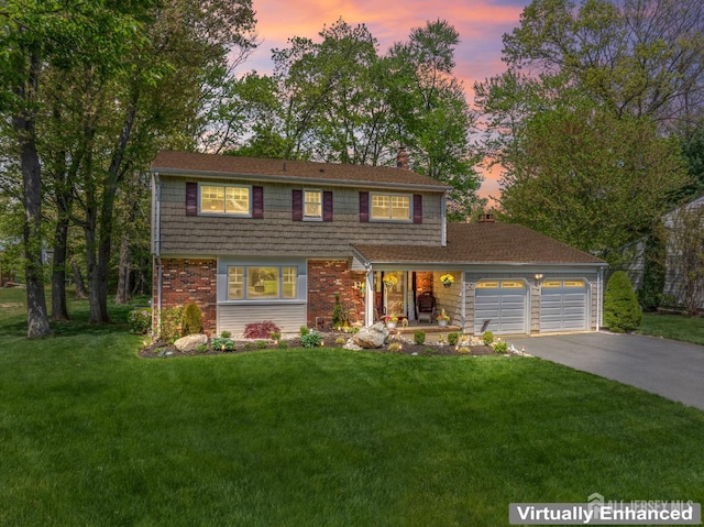 view of front of home with a chimney, a garage, driveway, a lawn, and brick siding