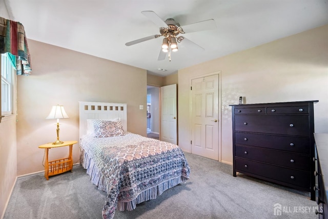 carpeted bedroom featuring baseboards and a ceiling fan