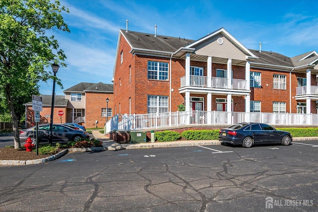 view of front of property featuring brick siding and uncovered parking