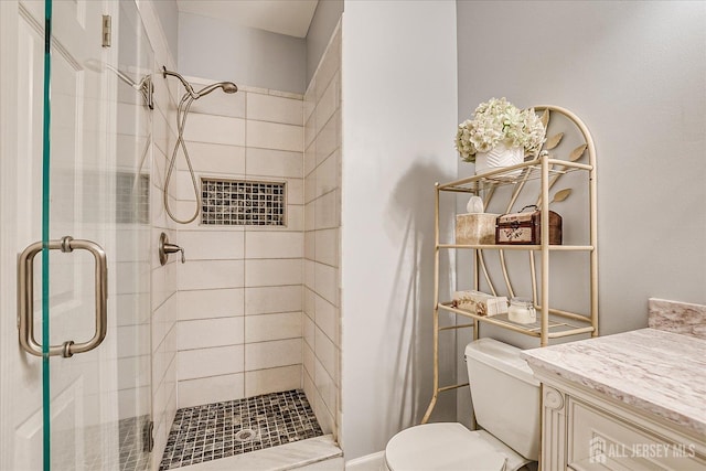 full bathroom featuring toilet, a shower stall, and vanity