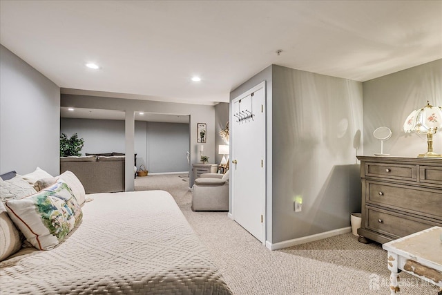 bedroom featuring light carpet, baseboards, and recessed lighting