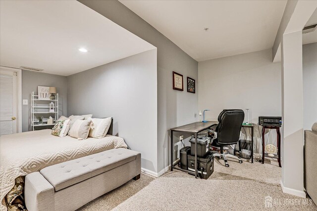 bedroom with carpet flooring, an office area, and baseboards
