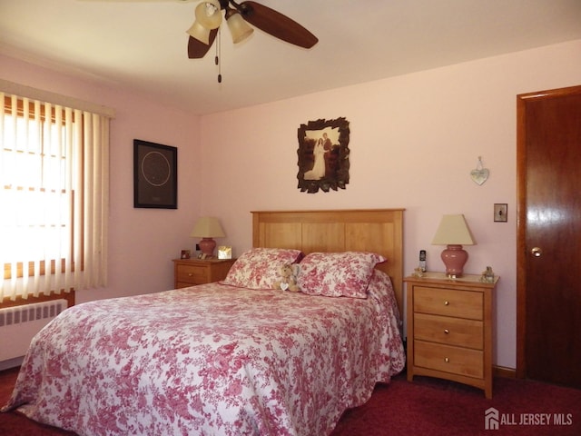 bedroom with carpet floors, radiator heating unit, and ceiling fan