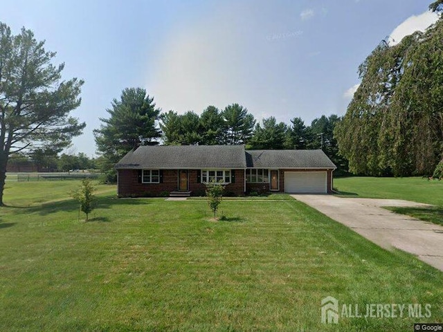 ranch-style house with a garage and a front lawn