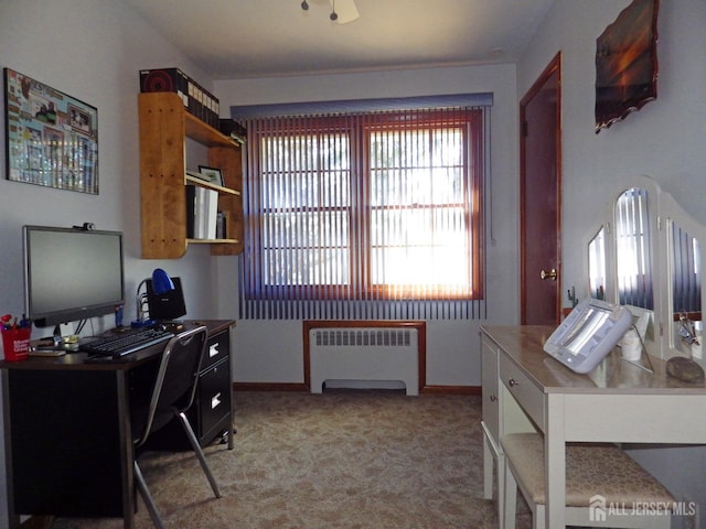 home office with baseboards, light colored carpet, and radiator