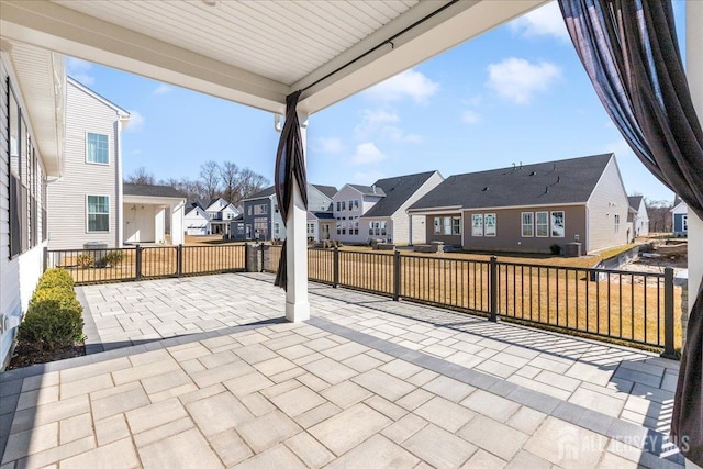 view of patio / terrace featuring a residential view and fence