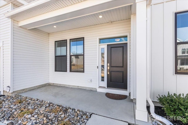 doorway to property featuring board and batten siding