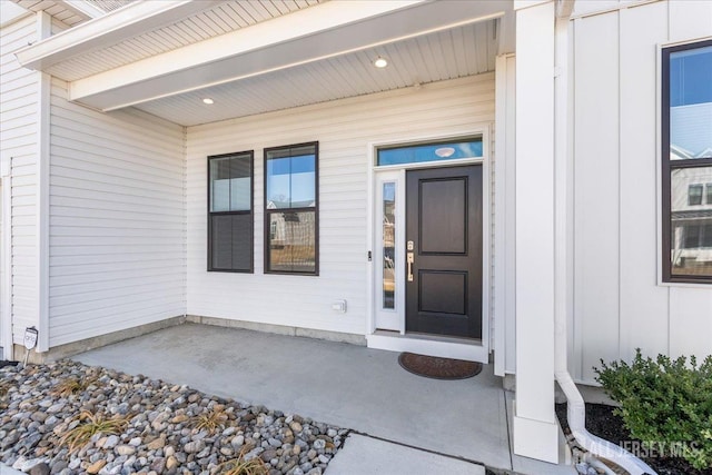 entrance to property with covered porch and board and batten siding