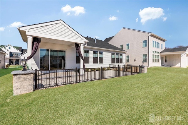 rear view of property with a patio and a lawn