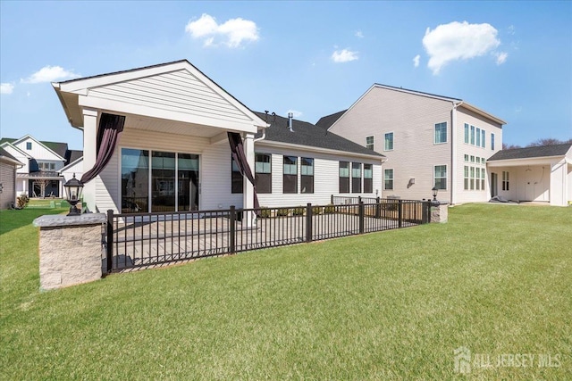 back of property featuring a lawn, fence, and a patio area