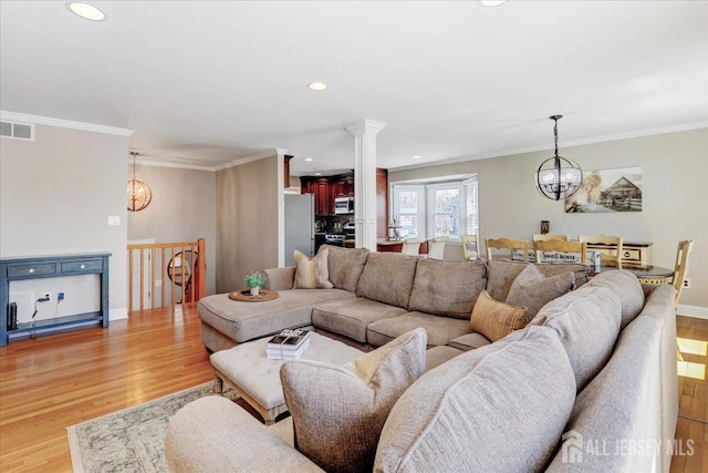 16 Dutch Valley Rd, Howell, NJ 07731 - living room featuring a chandelier, light wood-style floors, crown molding, recessed lighting, and baseboards