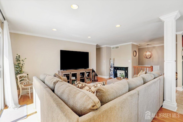 16 Dutch Valley Rd, Howell, NJ 07731 - living room with decorative columns, recessed lighting, light wood-style flooring, a chandelier, and baseboards
