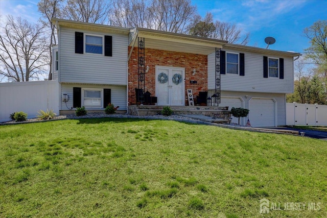 16 Dutch Valley Rd, Howell, NJ 07731 - split foyer home featuring a garage, brick siding, and asphalt driveway