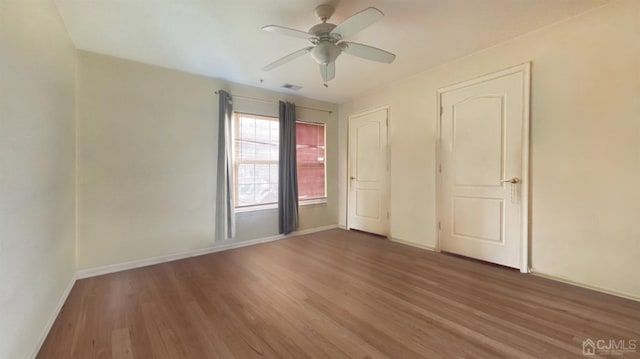 unfurnished bedroom with dark hardwood / wood-style floors and ceiling fan